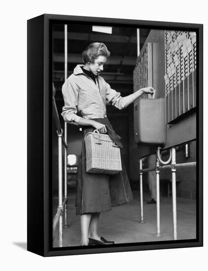Young Lady Modeling New Line of Clothing While Getting Her Time Card Punched-Yale Joel-Framed Premier Image Canvas