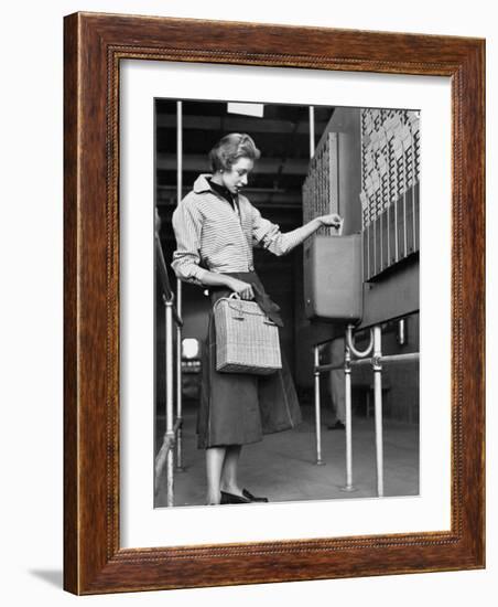 Young Lady Modeling New Line of Clothing While Getting Her Time Card Punched-Yale Joel-Framed Photographic Print