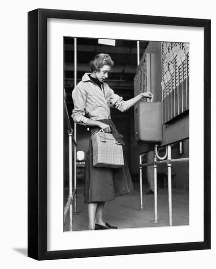 Young Lady Modeling New Line of Clothing While Getting Her Time Card Punched-Yale Joel-Framed Photographic Print
