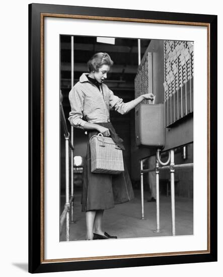 Young Lady Modeling New Line of Clothing While Getting Her Time Card Punched-Yale Joel-Framed Photographic Print