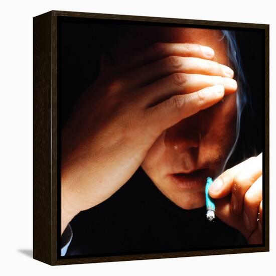 Young Man About to Take a Drag on a Marijuana Cigarette Wrapped in Blue Paper-Co Rentmeester-Framed Premier Image Canvas