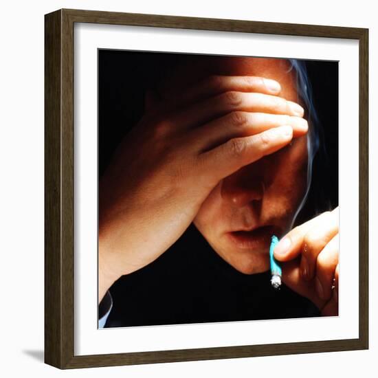 Young Man About to Take a Drag on a Marijuana Cigarette Wrapped in Blue Paper-Co Rentmeester-Framed Photographic Print