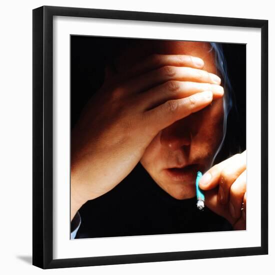 Young Man About to Take a Drag on a Marijuana Cigarette Wrapped in Blue Paper-Co Rentmeester-Framed Photographic Print