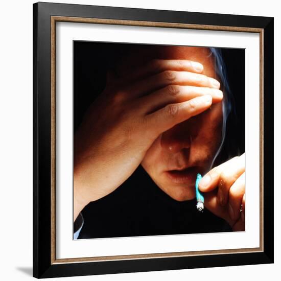 Young Man About to Take a Drag on a Marijuana Cigarette Wrapped in Blue Paper-Co Rentmeester-Framed Photographic Print