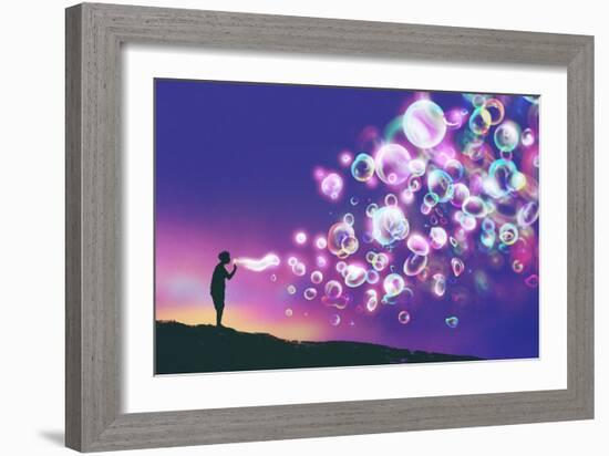 Young Man Blowing Glowing Soap Bubbles against Evening Sky,Illustration Painting-Tithi Luadthong-Framed Art Print