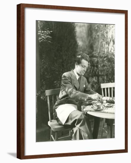 Young Man Having Breakfast at Outdoor Table-null-Framed Photo