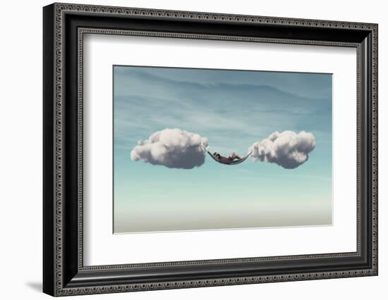 Young Man Relaxes in a Hammock between Two Clouds.-Orla-Framed Photographic Print