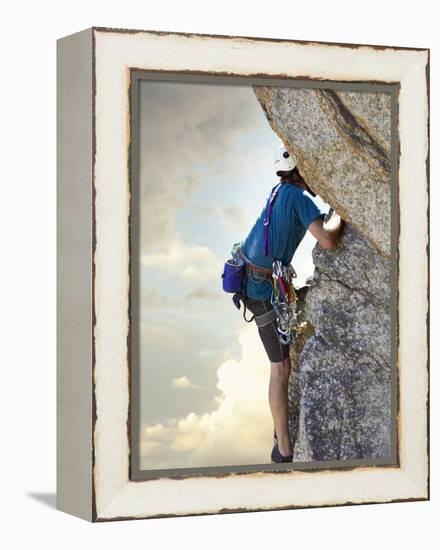 Young man rock climbing up a vertical cliff-null-Framed Premier Image Canvas