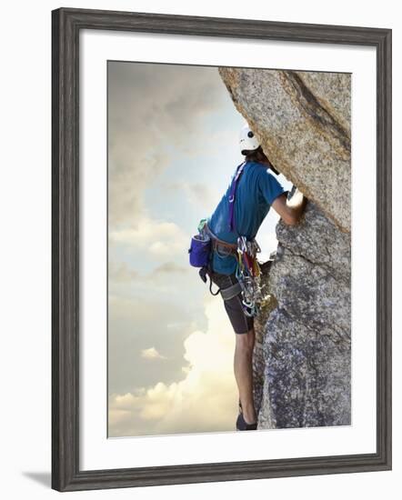 Young man rock climbing up a vertical cliff-null-Framed Photographic Print