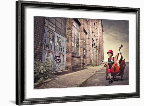 Young Man Sitting On An Armchair On A City Street And Playing The Cello-olly2-Framed Art Print