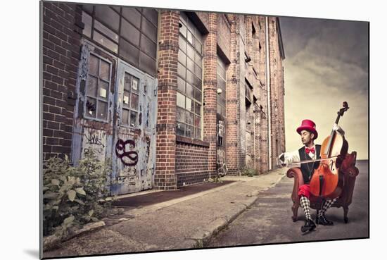Young Man Sitting On An Armchair On A City Street And Playing The Cello-olly2-Mounted Art Print