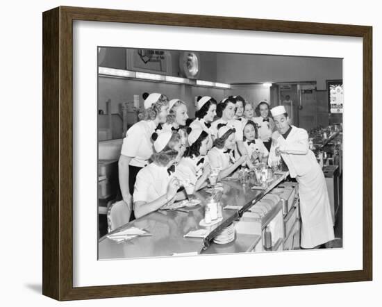 Young Man Surrounded by a Group of College Women in His Soda Fountain-null-Framed Photo