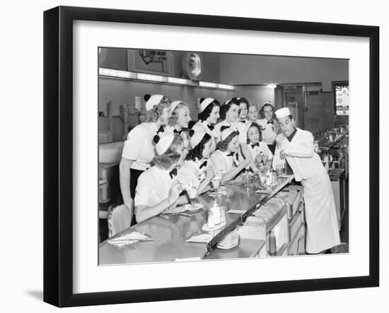 Young Man Surrounded by a Group of College Women in His Soda Fountain-null-Framed Photo