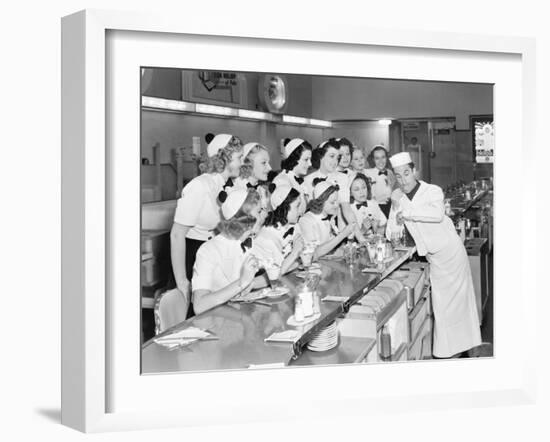 Young Man Surrounded by a Group of College Women in His Soda Fountain-null-Framed Photo