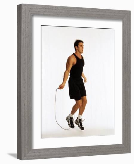 Young Man Working Out with Jump Rope-Chris Trotman-Framed Photographic Print