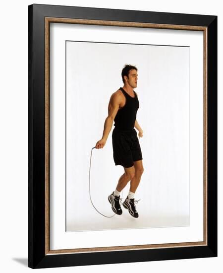 Young Man Working Out with Jump Rope-Chris Trotman-Framed Photographic Print