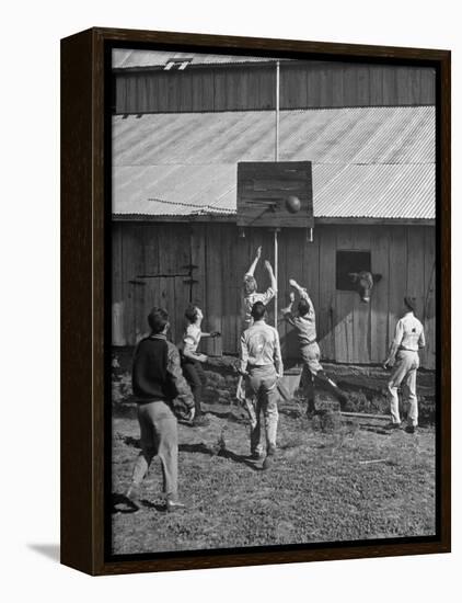 Young Men Playing Basketball with a Homemade Basket in a Farmyard-null-Framed Premier Image Canvas