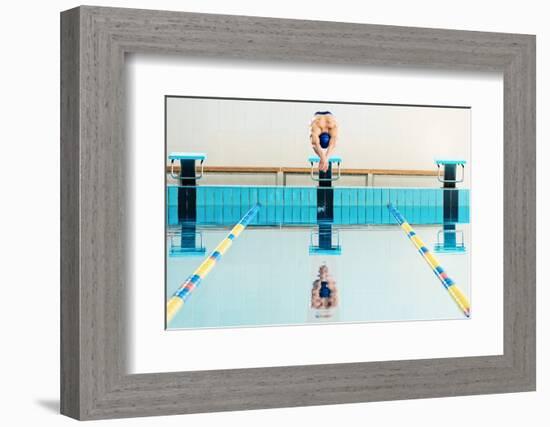 Young Muscular Swimmer Jumping from Starting Block in a Swimming Pool-NejroN Photo-Framed Photographic Print