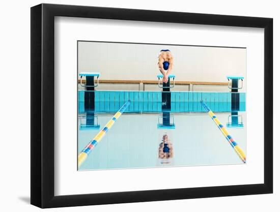 Young Muscular Swimmer Jumping from Starting Block in a Swimming Pool-NejroN Photo-Framed Photographic Print