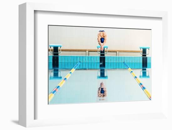 Young Muscular Swimmer Jumping from Starting Block in a Swimming Pool-NejroN Photo-Framed Photographic Print