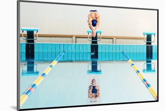 Young Muscular Swimmer Jumping from Starting Block in a Swimming Pool-NejroN Photo-Mounted Photographic Print