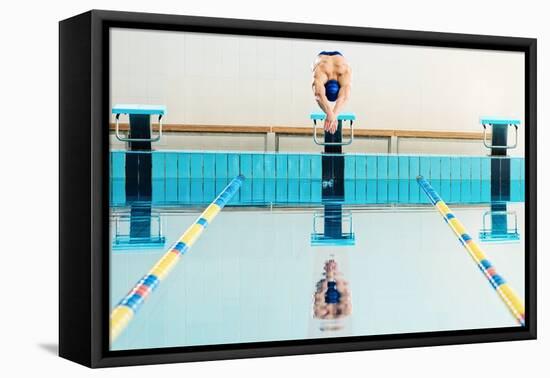 Young Muscular Swimmer Jumping from Starting Block in a Swimming Pool-NejroN Photo-Framed Premier Image Canvas