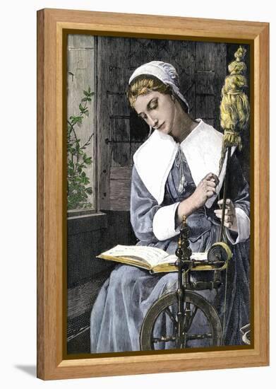 Young Puritan Woman Reading While Spinning at Her Wheel-null-Framed Premier Image Canvas