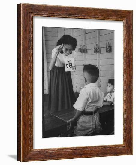 Young School Teacher Explaining to a Little Chinese Boy the Writings on Card That She Is Holding-null-Framed Photographic Print