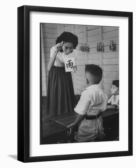 Young School Teacher Explaining to a Little Chinese Boy the Writings on Card That She Is Holding-null-Framed Photographic Print