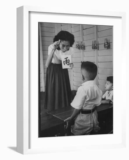 Young School Teacher Explaining to a Little Chinese Boy the Writings on Card That She Is Holding-null-Framed Photographic Print