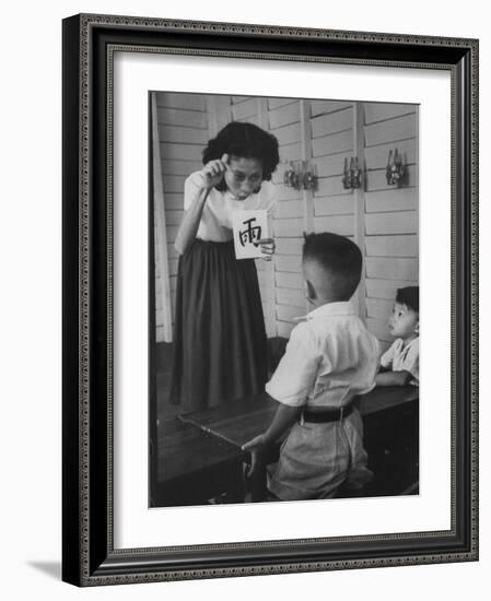 Young School Teacher Explaining to a Little Chinese Boy the Writings on Card That She Is Holding-null-Framed Photographic Print