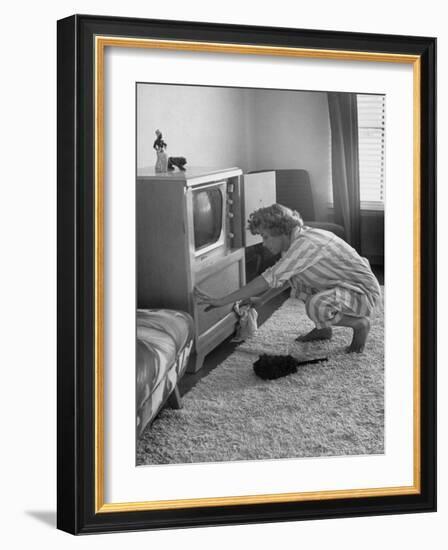 Young Woman Attending to Her Housework by Dusting Off Her Television Set-Nina Leen-Framed Photographic Print