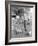 Young Woman Dressed as a Farmer Bringing Food to the Chicken-null-Framed Photo