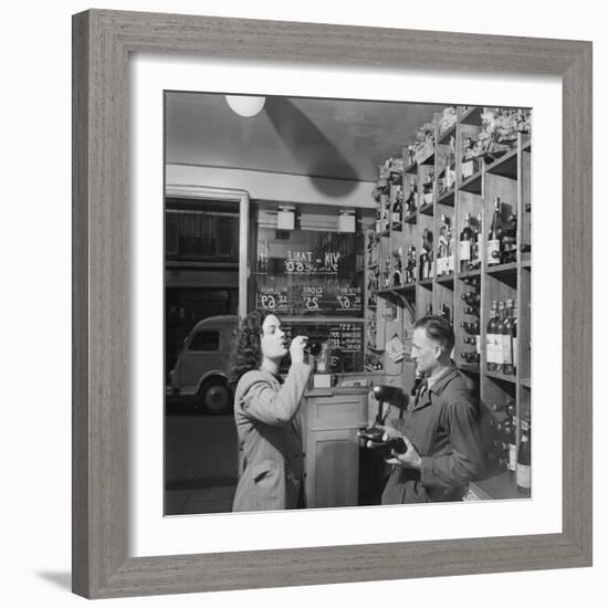 Young Woman Drinking a Bottle of Coca Cola in a Shop, Paris, France, 1950-Mark Kauffman-Framed Photographic Print