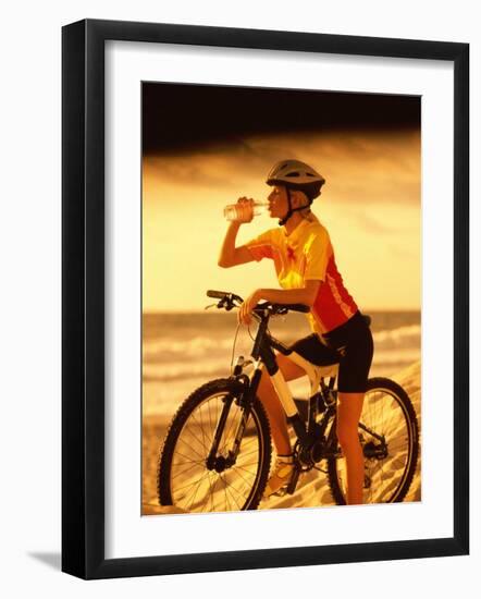 Young Woman Drinking Water Sitting on a Bicycle-null-Framed Photographic Print