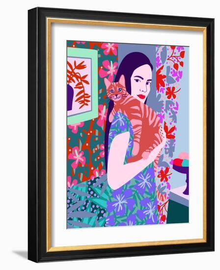 Young woman holding a cat in bright decorated interior.-Galina Kamenskaya-Framed Art Print