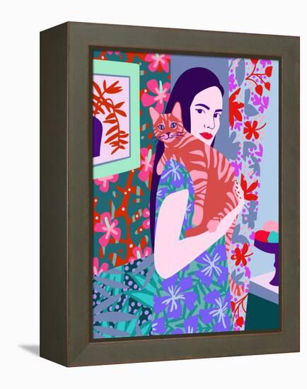 Young woman holding a cat in bright decorated interior.-Galina Kamenskaya-Framed Stretched Canvas