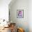 Young woman holding a cat in bright decorated interior.-Galina Kamenskaya-Framed Premium Giclee Print displayed on a wall