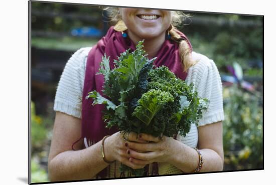 Young Woman Holding Fresh Vegetables Out Of The Garden-Justin Bailie-Mounted Photographic Print