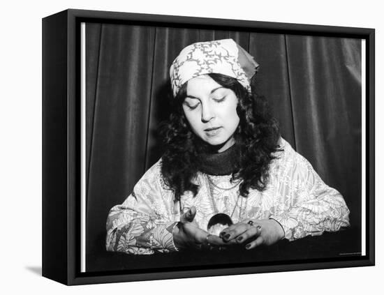 Young Woman Holds and Interprets a Crystal Ball-null-Framed Premier Image Canvas