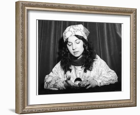 Young Woman Holds and Interprets a Crystal Ball-null-Framed Photographic Print