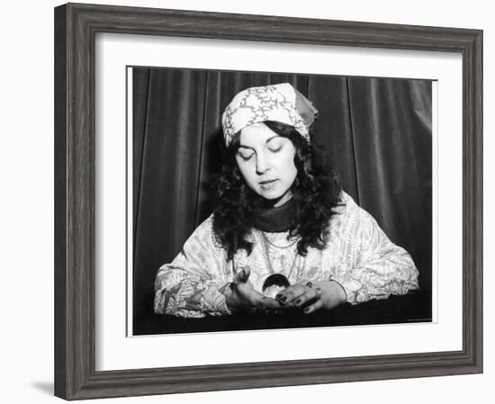 Young Woman Holds and Interprets a Crystal Ball-null-Framed Photographic Print