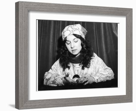 Young Woman Holds and Interprets a Crystal Ball-null-Framed Photographic Print