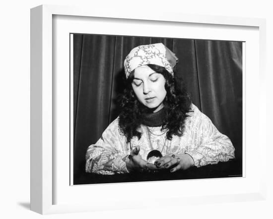 Young Woman Holds and Interprets a Crystal Ball-null-Framed Photographic Print