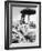 Young Woman in a Bikini Prepares to Go Snorkelling by Putting on Her Rubber Flippers-null-Framed Photographic Print