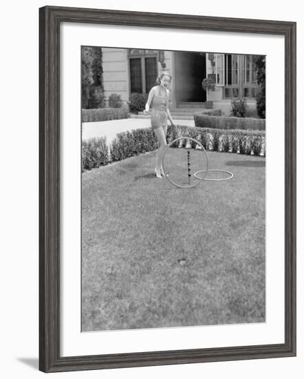 Young Woman in a Sun Suit Playing with Rings in the Yard-null-Framed Photo