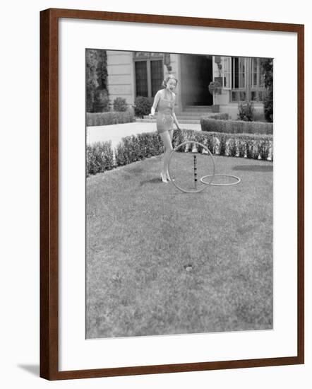 Young Woman in a Sun Suit Playing with Rings in the Yard-null-Framed Photo