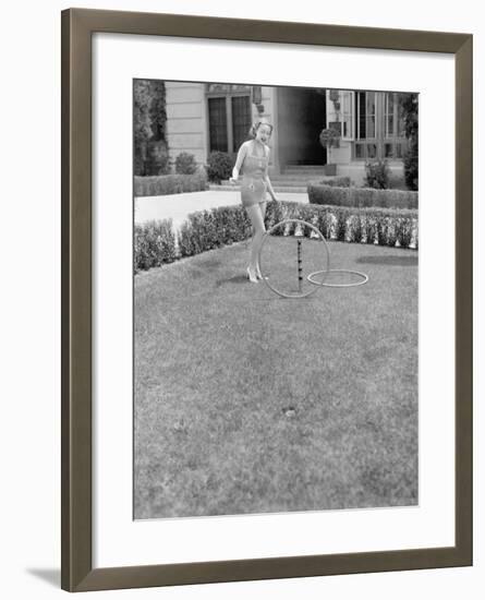 Young Woman in a Sun Suit Playing with Rings in the Yard-null-Framed Photo