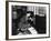 Young Woman in an Office Next to a Safe, Looking over Her Shoulder-null-Framed Photo