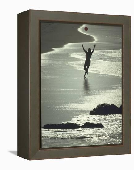 Young Woman in Silhouette Running Along Beach at Twilight Throwing Beach Ball Up in the Air-Co Rentmeester-Framed Premier Image Canvas